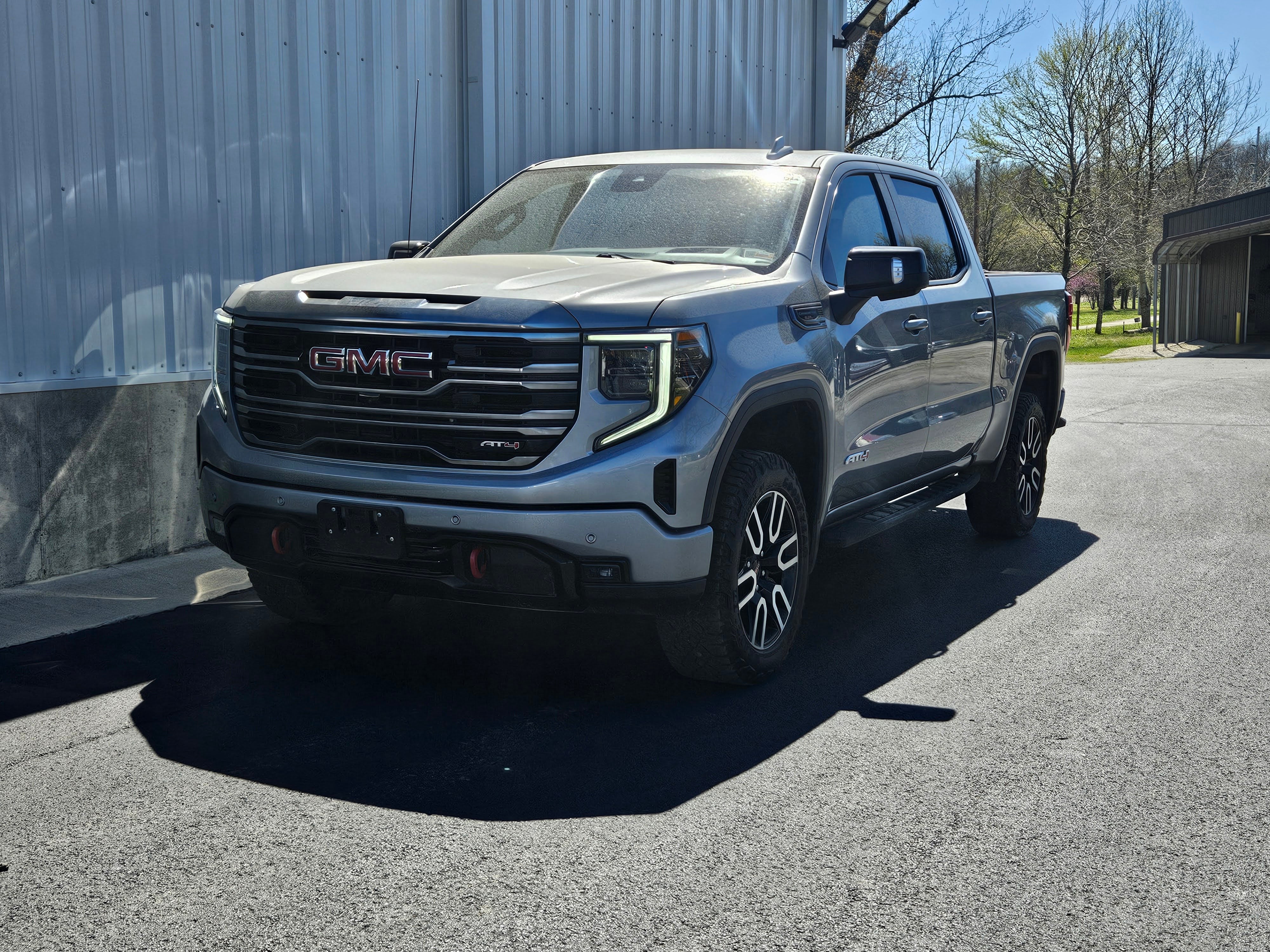 2023 GMC Sierra 1500 AT4 in Sterling Metallic — front three-quarter view