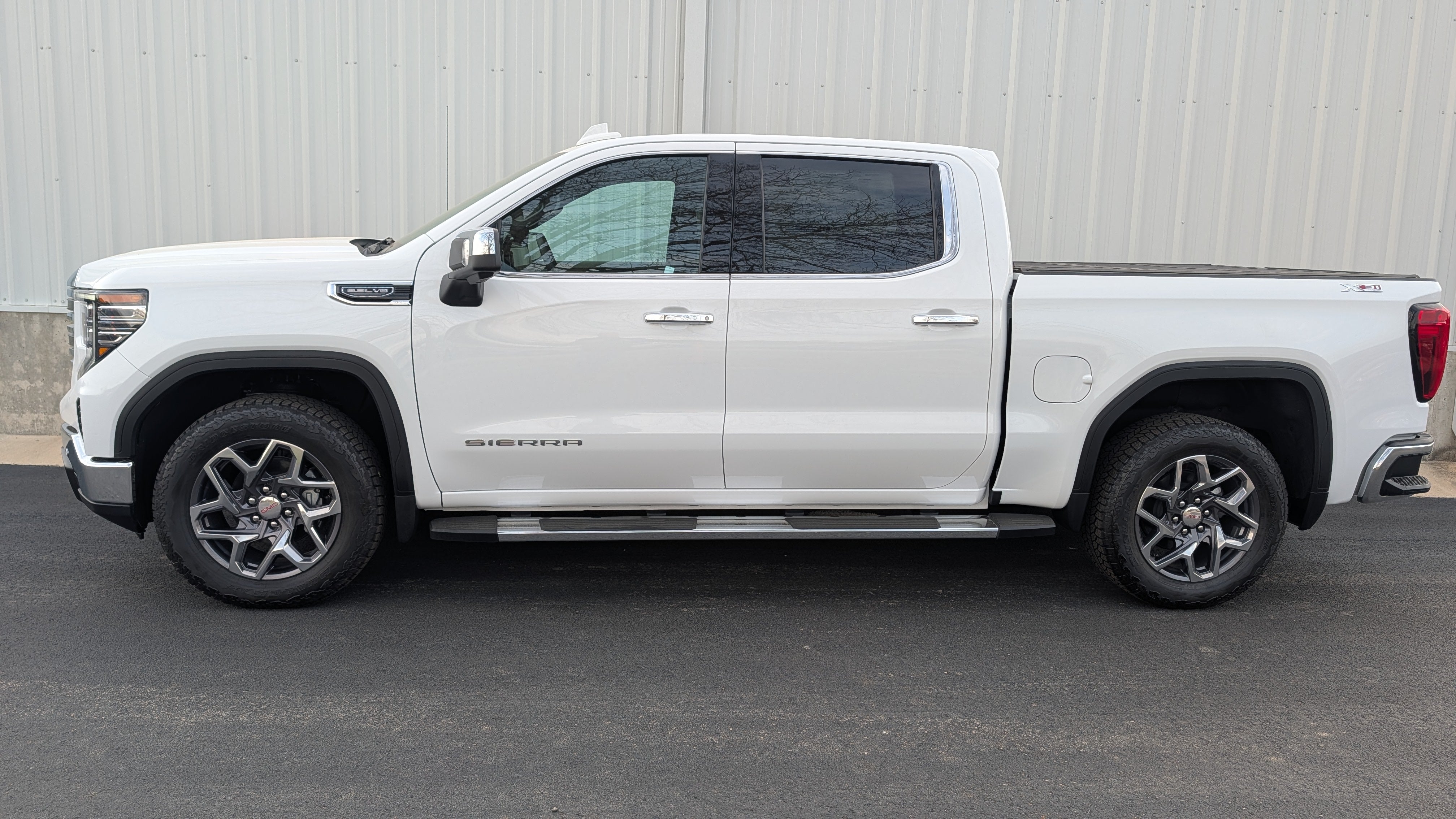 2026 GMC Sierra 1500 SLT in Summit White — front three-quarter view